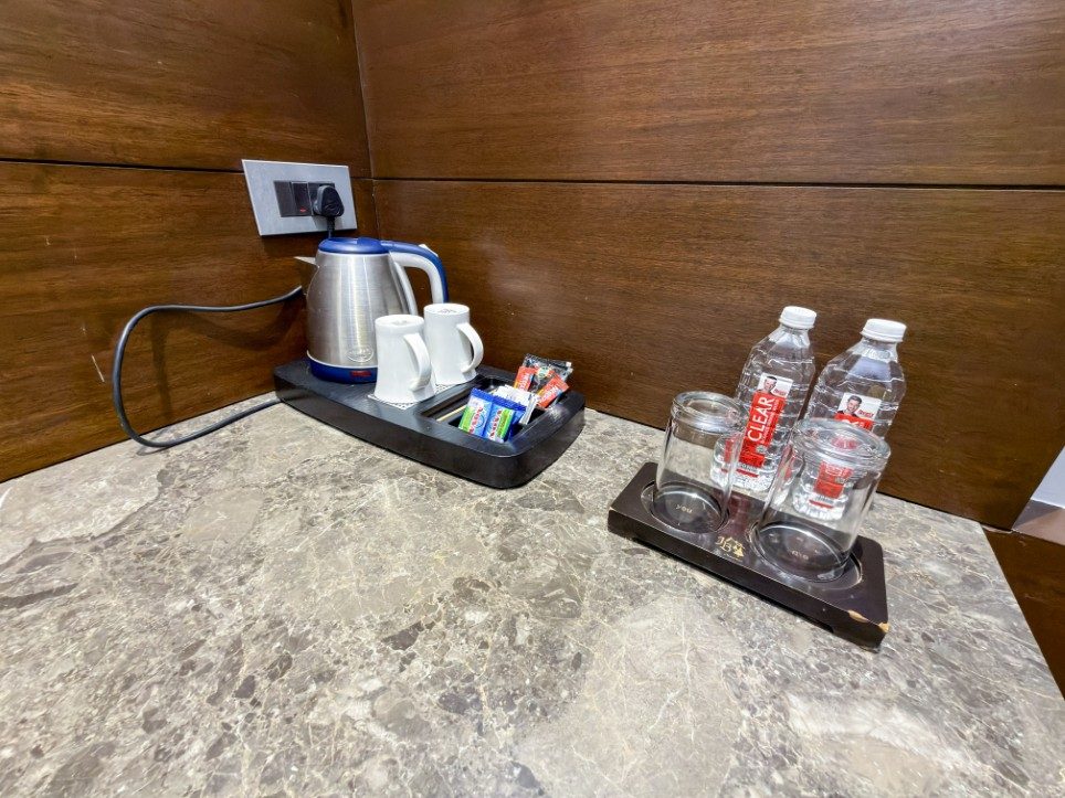 Electric kettle, tea, coffee and bottled water in a Business Room, Hotel Sawera Grand