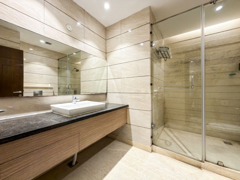 Marble bathroom with glass walk-in shower in a Business Room with Balcony, Hotel Sawera Grand