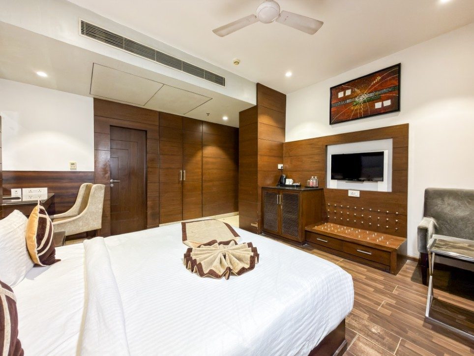 The king bed and television wall of a Business Room with Balcony, Hotel Sawera Grand