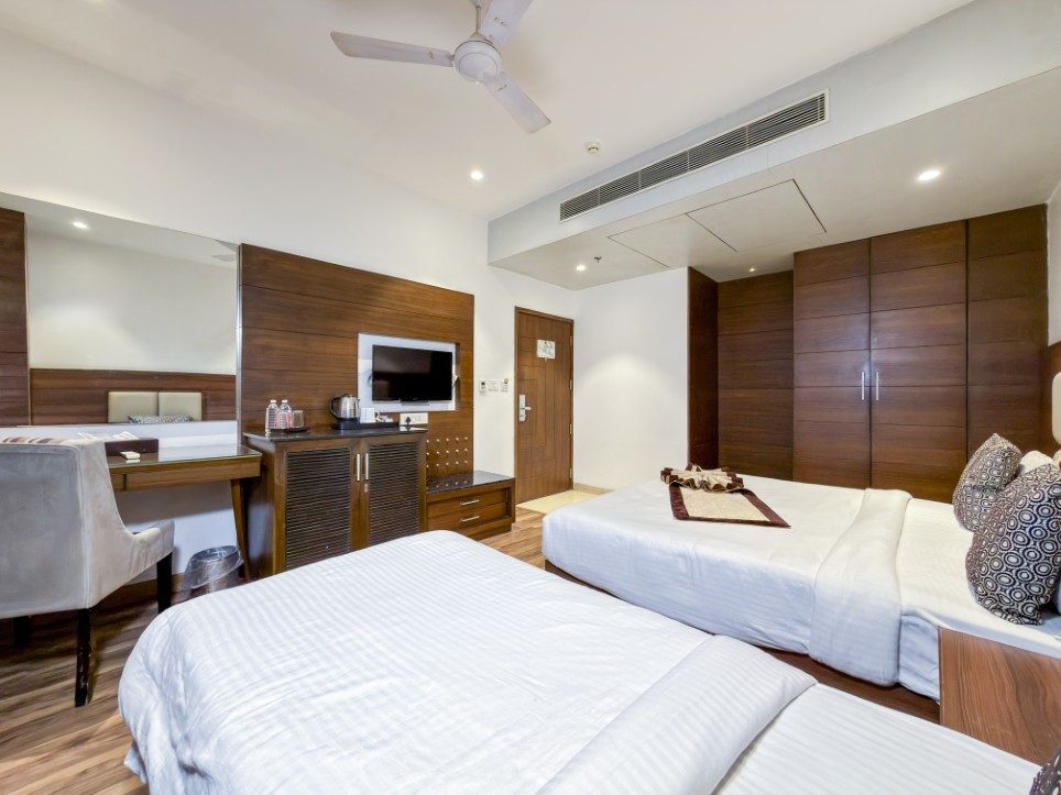 A double bed and a separate single bed in the Executive Triple Room, Hotel Sawera Grand