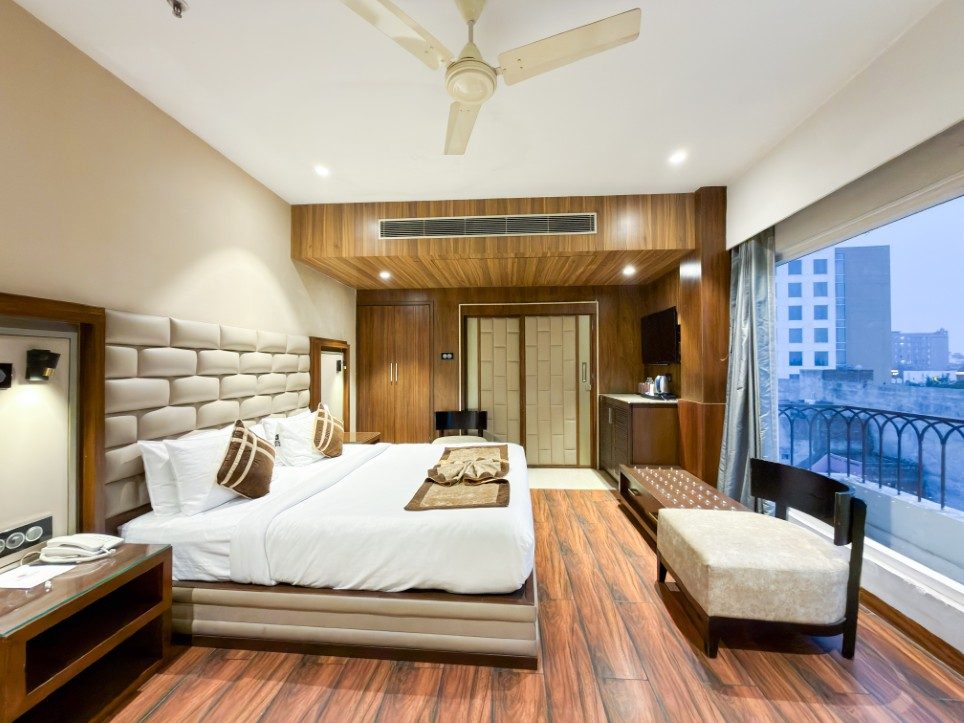 The K L Suite at Hotel Sawera Grand, Amritsar, with its full-width glass wall and city view
